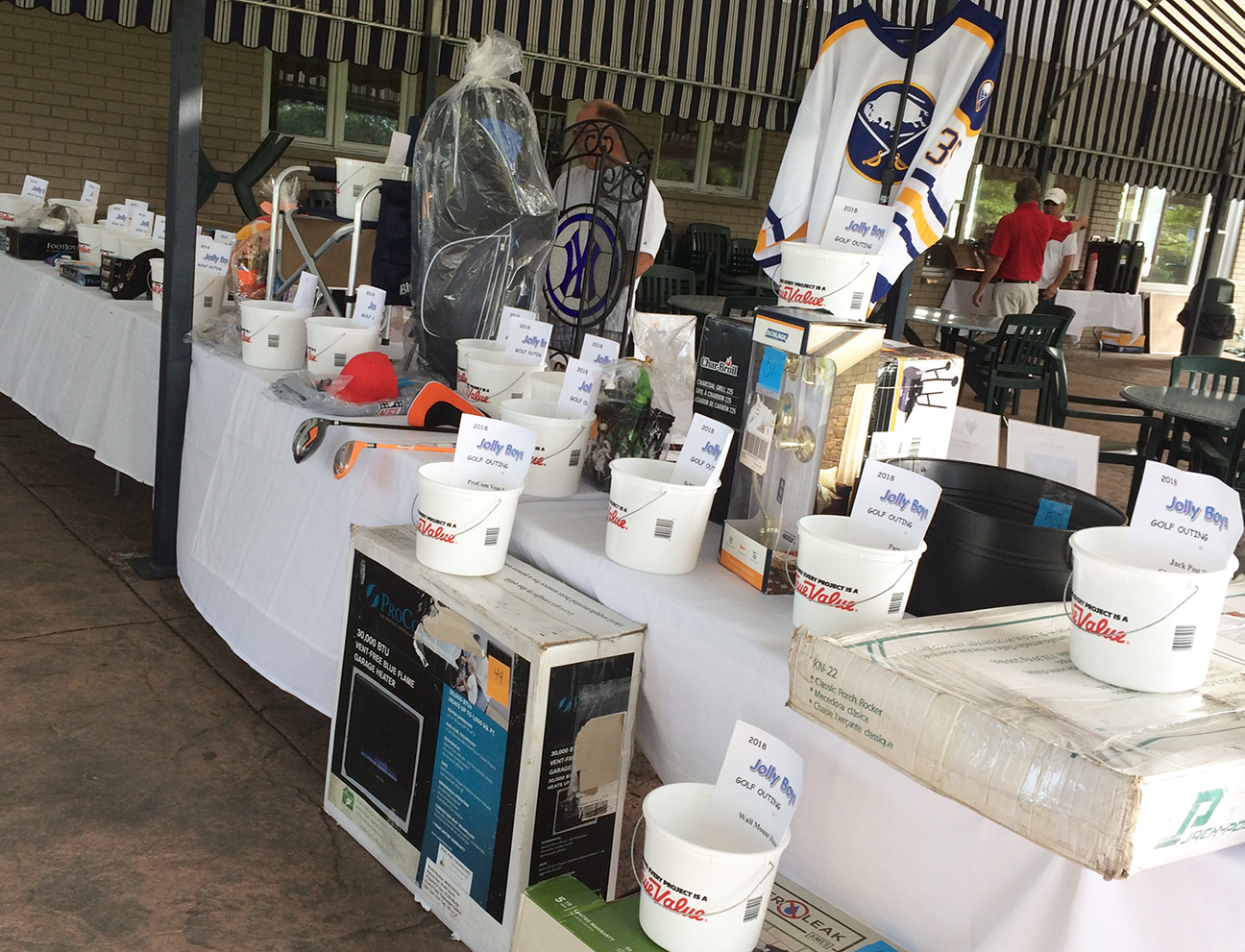 Raffle prizes displayed under an outdoor pavilion